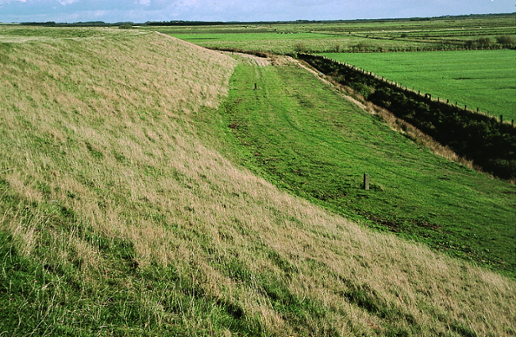 Deichverteidigung nördlich von Oldsum im Jahre 2004: Auf der Innenseite fehlt der standardmäßige ganzjährig befahrbare Deichverteidigungsweg (als Notlösung dient die Asphaltdecke des Deckwerks der Außenböschung) (Quelle: aus STADELMANN (2008, S. 553)) Deichverteidigung nördlich von Oldsum im Jahre 2004: Auf der Innenseite fehlt der standardmäßige ganzjährig befahrbare Deichverteidigungsweg (als Notlösung dient die Asphaltdecke des Deckwerks der Außenböschung)